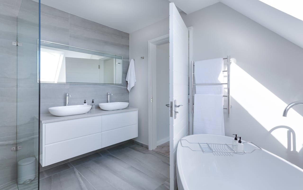3D rendering of an updated, all-white master bathroom