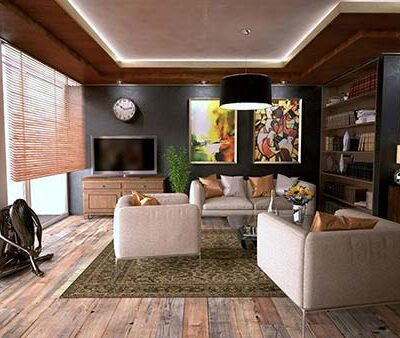 An Industrial-style living room with wooden floorboards, a two-seater sofa, and two armchairs