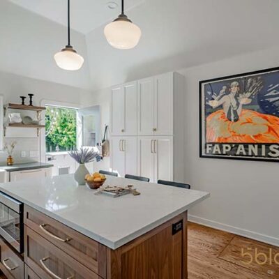 A remodeled, modern kitchen in neutral tones