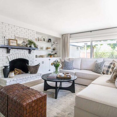 A Spanish-style living room with a cream-colored sectional sofa and a fireplace