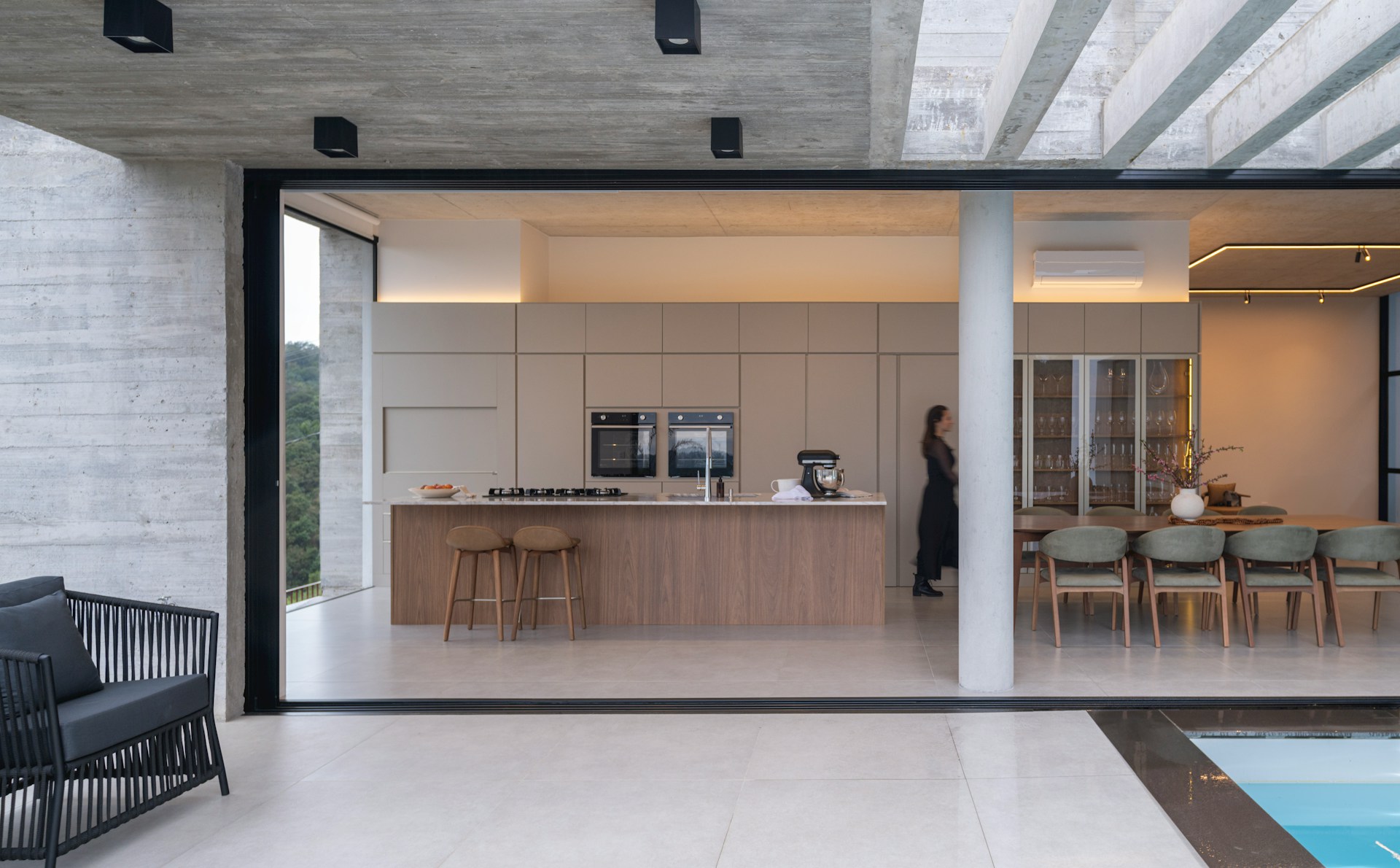 Indoor-outdoor kitchen with sliding glass doors and covered patio seating