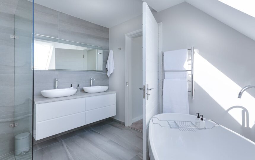 minimalist bathroom with white bathtub and double sinks