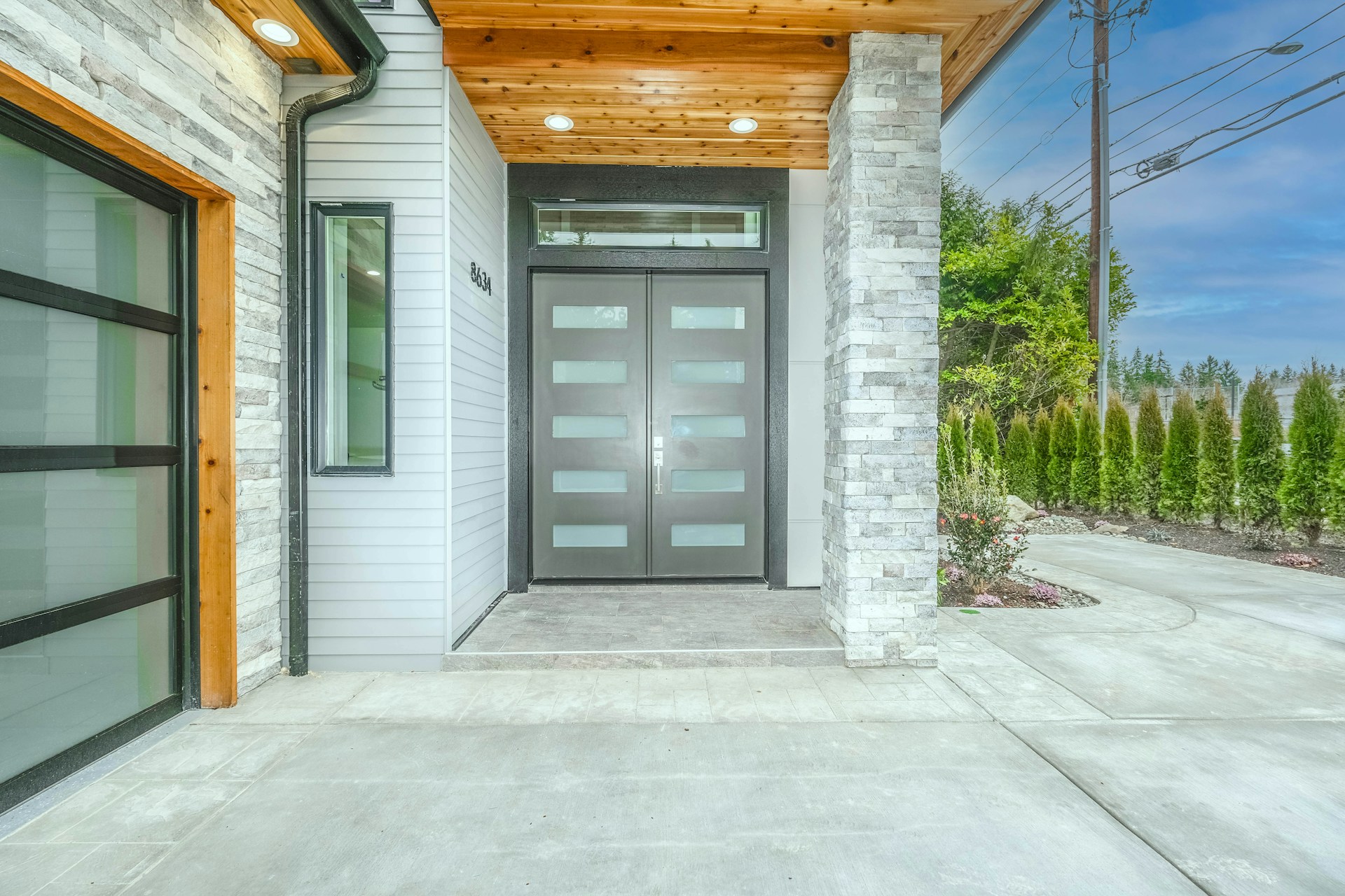 Modern Los Angeles entryway featuring stone columns and energy-efficient materials used in contemporary home remodeling